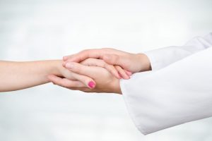 bigstock-Doctor-Holding-Patient-Hand-Cl-159730853-e1507555593968